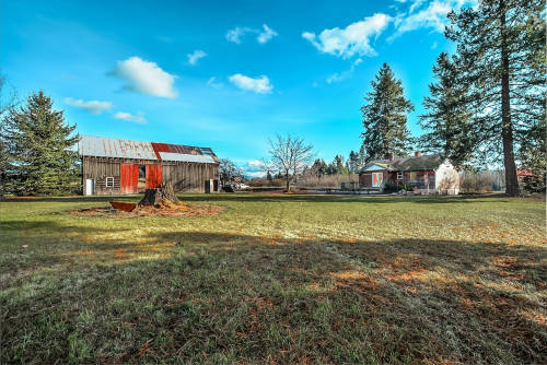 Farmhouse and barn on ranch in Idaho.